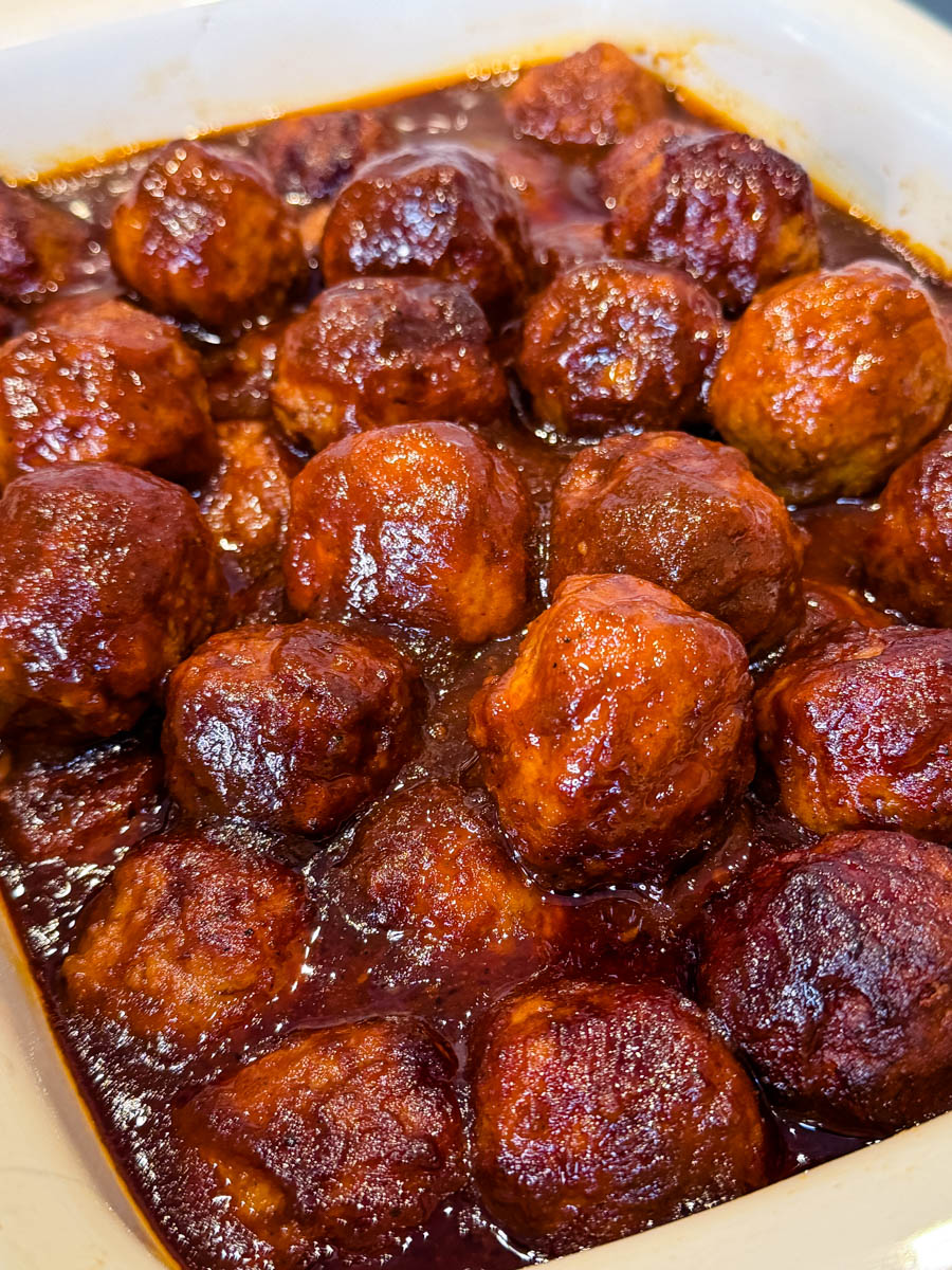 Close-up of baked BBQ meatballs with caramelized edges and thick sauce