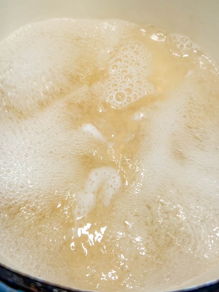Close-up of hot water bubbling in a pot for hot water cornbread