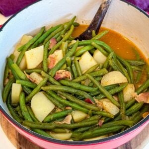Southern green beans and potatoes cooked with bacon in a savory broth and served in a Dutch oven.