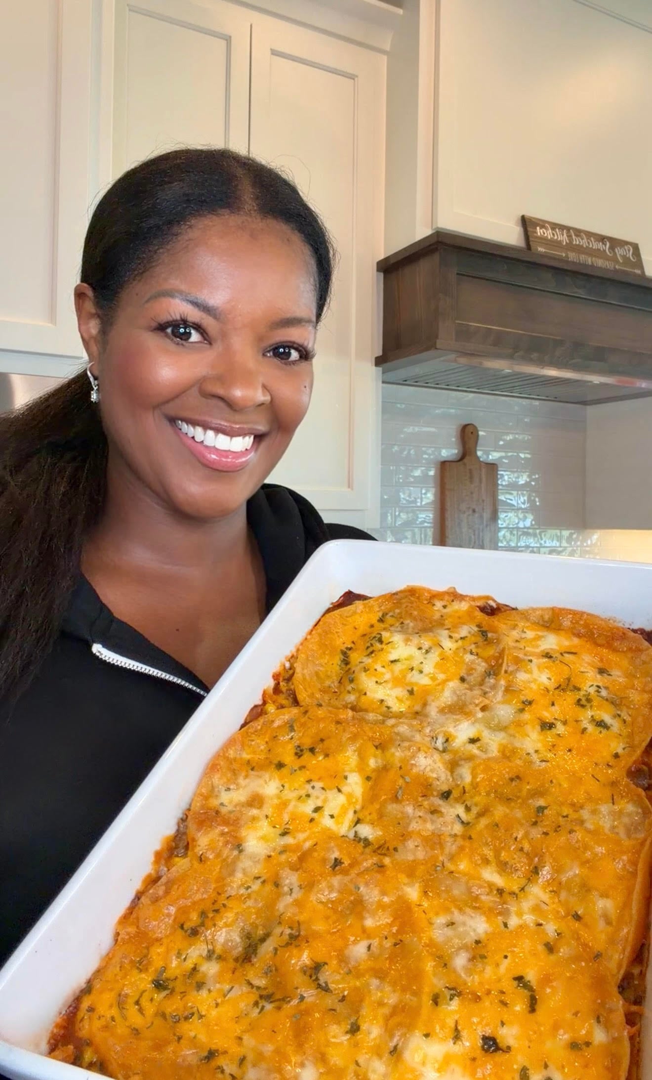 person holding enchilada casserole
