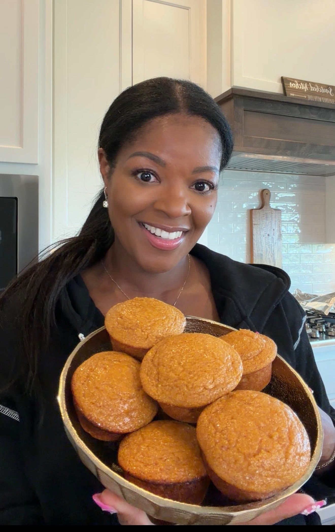 person holding a bowl of pumpkin cornbread