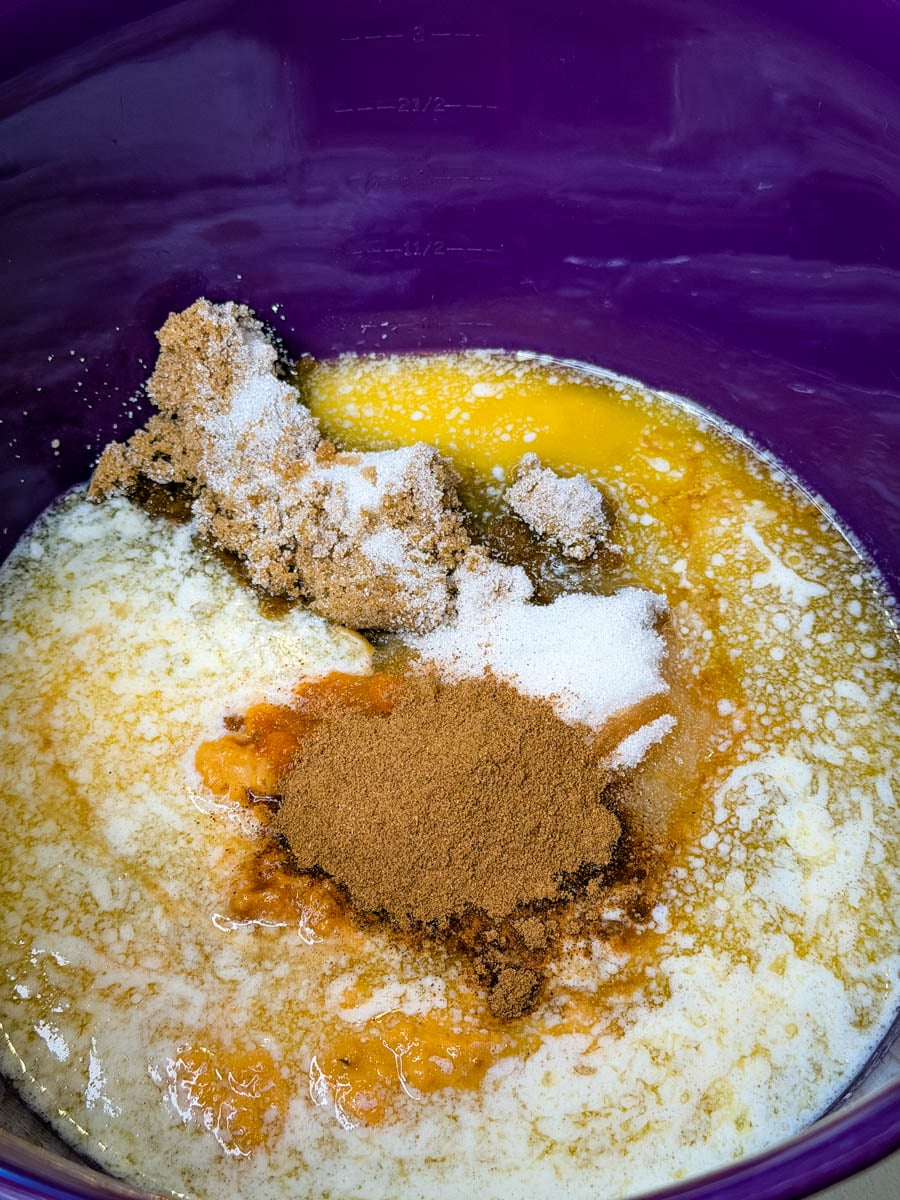 butter, pureed pumpkin, pumpkin pie spice, and eggs in a mixing bowl