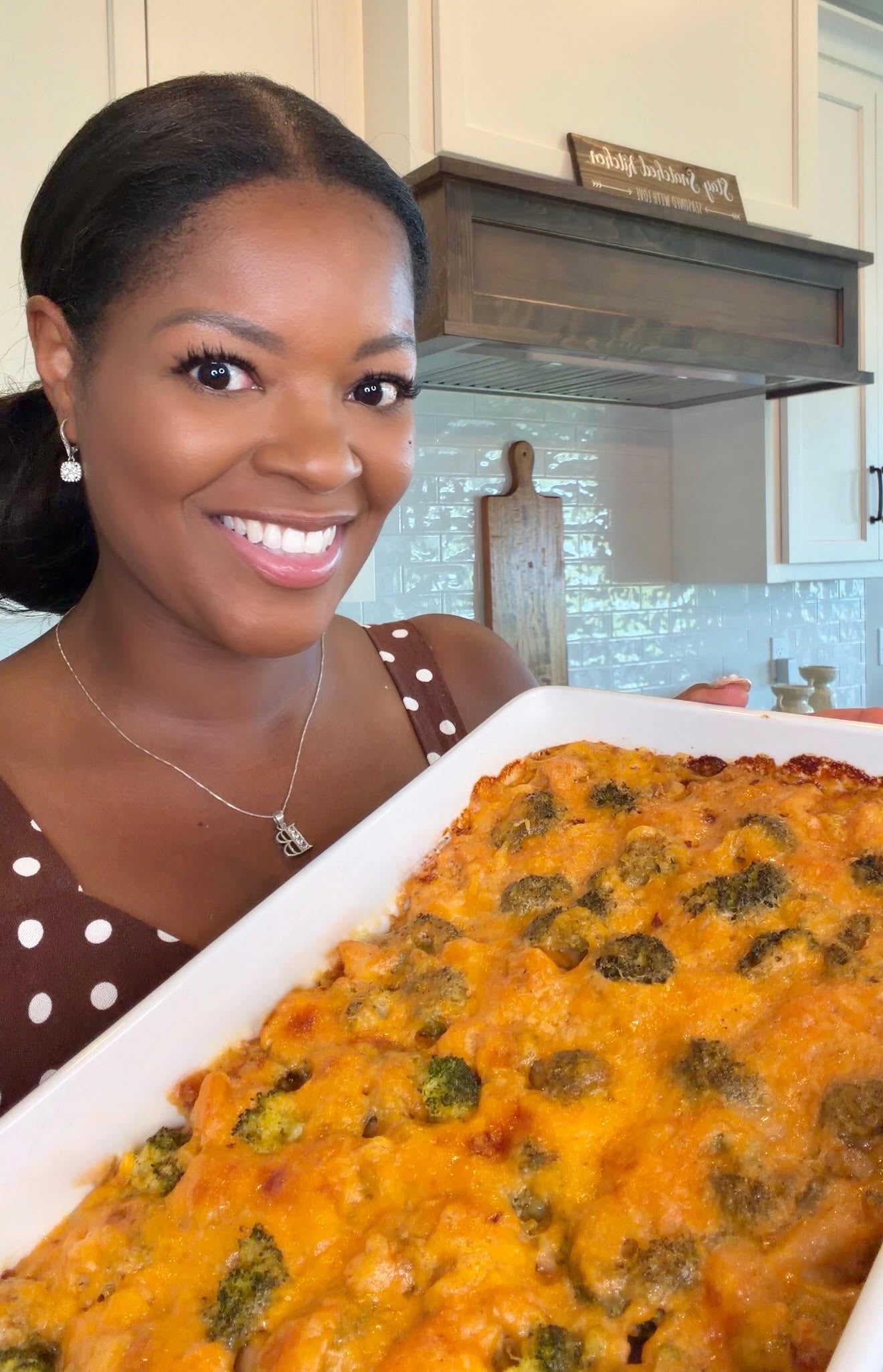 Brandi holding a pan of broccoli rice chicken casserole