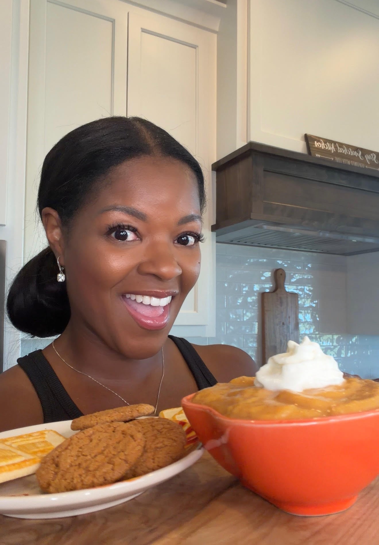 Brandi Crawford holding pumpkin pie dip and a plate of cookies