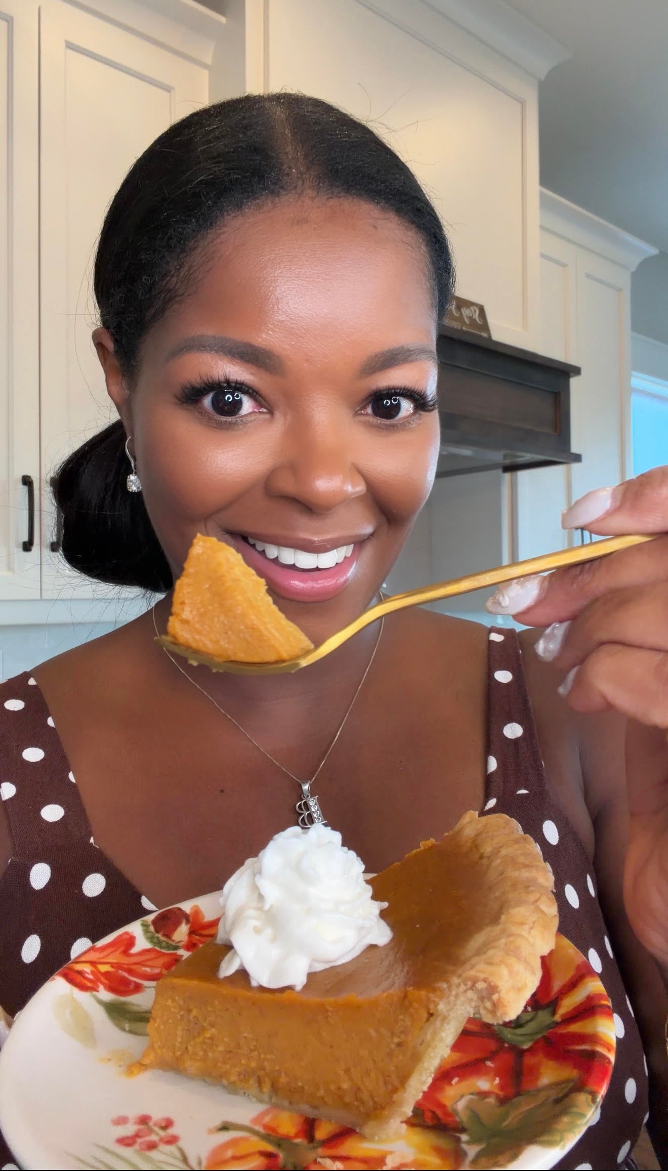 Brandi Crawford holding a slice of freshly baked pumpkin pie with frozen crust