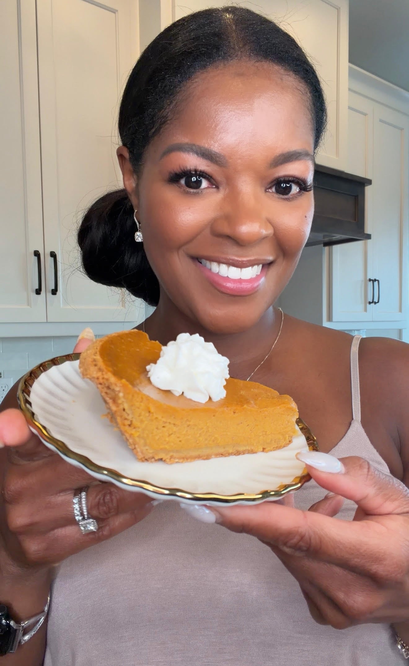 Brandi Crawford holding pumpkin pie with graham cracker crust