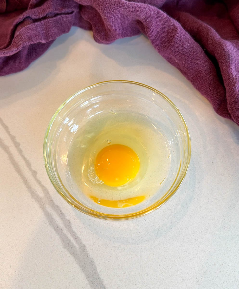 raw egg in a glass bowl