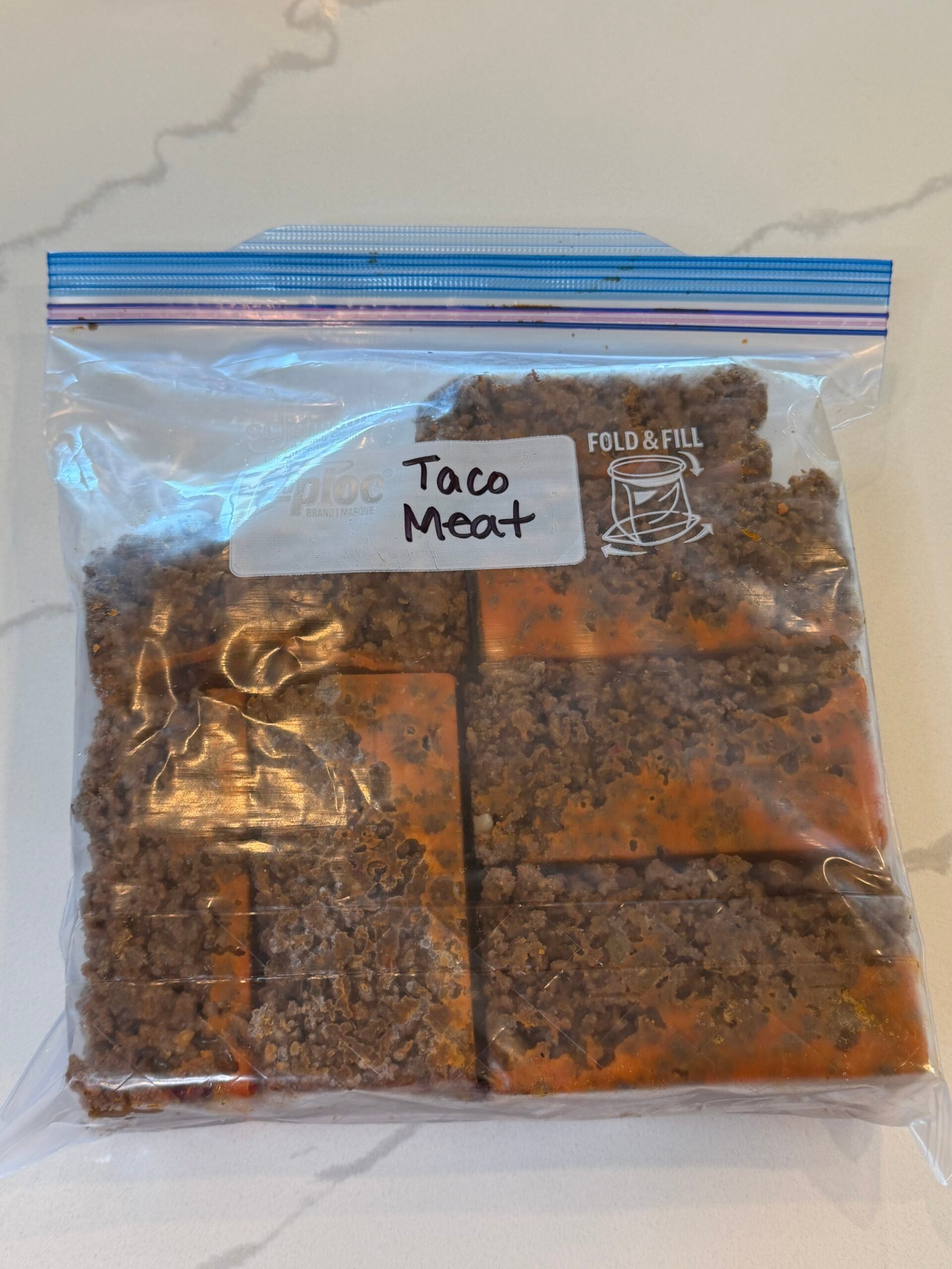 frozen taco meat in a plastic freezer bag